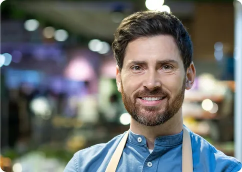 A retail employee wearing an apron